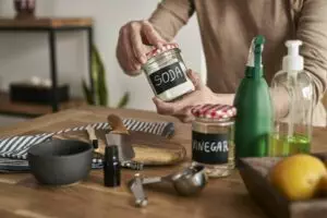 Unrecognizable person making cleaning product from ecological ingredients