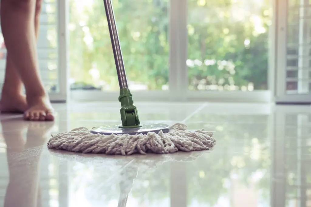 Asian women cleaning folk using mop tiles.